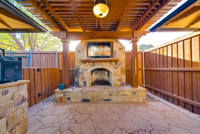 view of patio featuring an outdoor stone fireplace