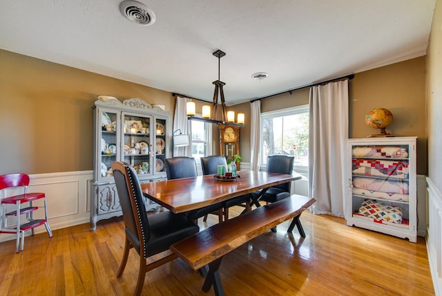 dining space with a chandelier and light wood-type flooring