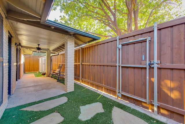 view of patio / terrace with a storage unit and ceiling fan