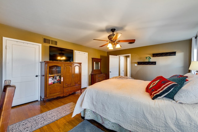 bedroom with wood-type flooring and ceiling fan