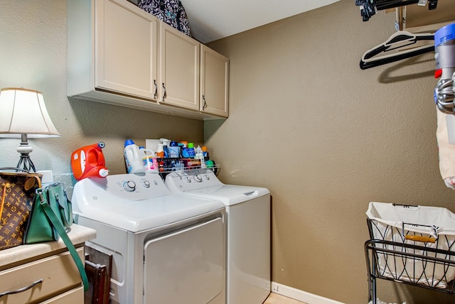 laundry area featuring cabinets and washing machine and clothes dryer