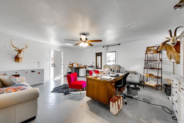 office with ceiling fan and a textured ceiling