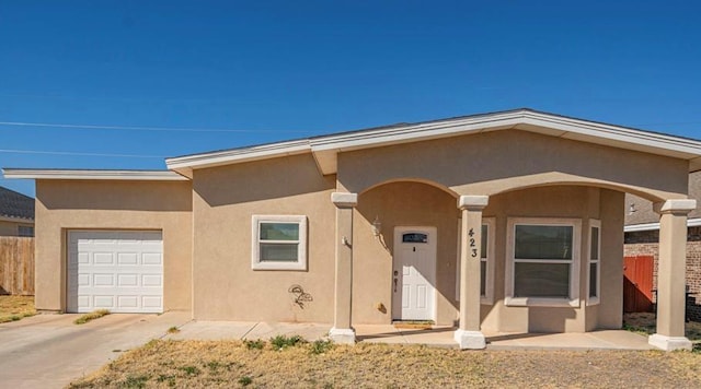 423 Elm Ave, Midland, TX 79705 - view of front of property with an attached garage, stucco siding, and concrete driveway