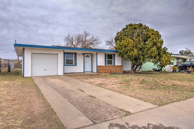 single story home with driveway, a front lawn, a garage, and fence