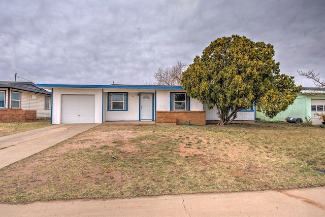 ranch-style house featuring a garage, concrete driveway, and a front lawn