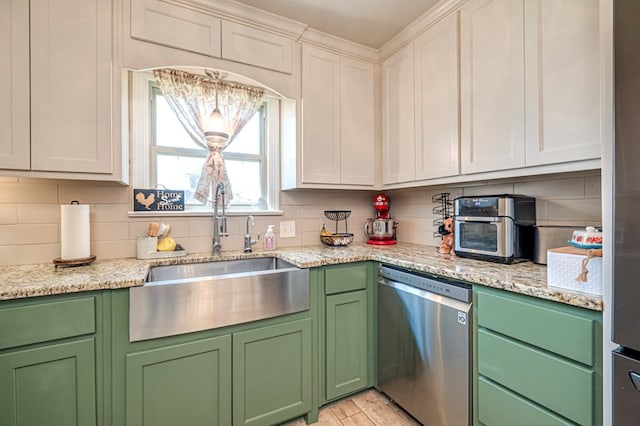 kitchen featuring stainless steel dishwasher, white cabinetry, sink, and tasteful backsplash