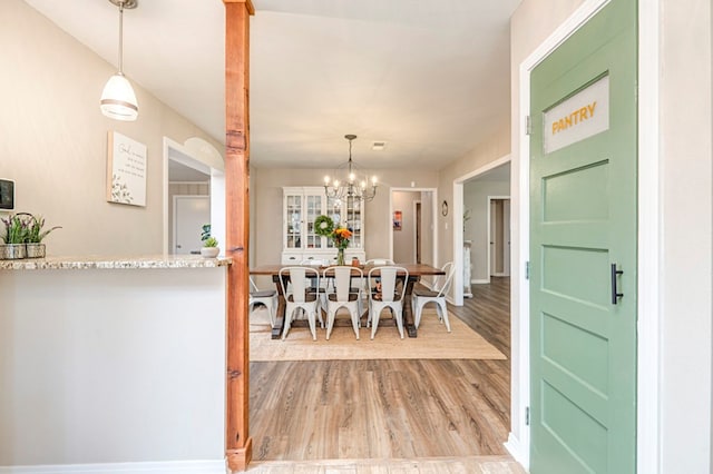 dining room featuring an inviting chandelier and light hardwood / wood-style flooring