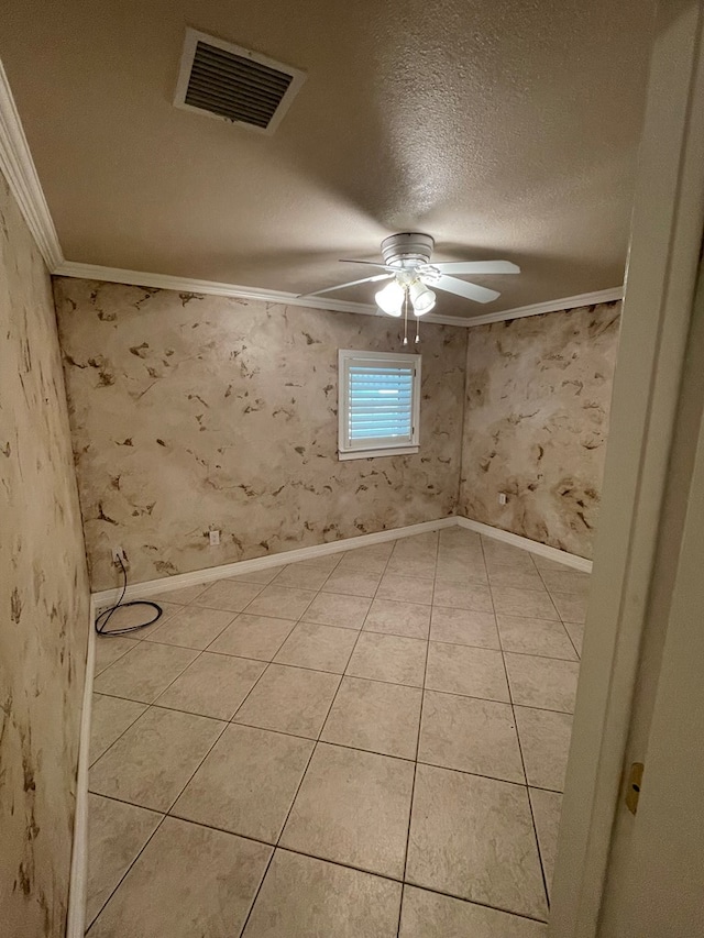 104 Salem Rd, Big Spring, TX 79720 - empty room with ornamental molding, light tile patterned floors, ceiling fan, baseboards, and a textured ceiling