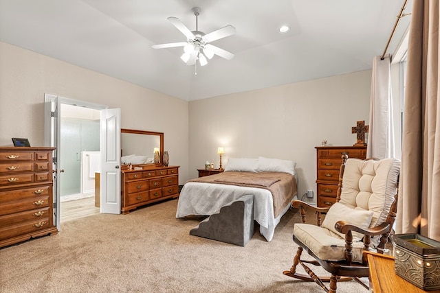 bedroom with ceiling fan, light colored carpet, and vaulted ceiling