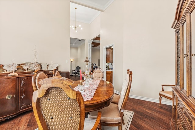 dining area featuring a high ceiling, dark hardwood / wood-style floors, ornamental molding, ornate columns, and a notable chandelier