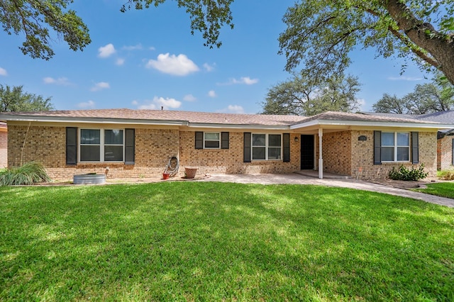 2408 Goddard Ct, Midland, TX 79705 - ranch-style home featuring a front lawn, brick siding, and a patio