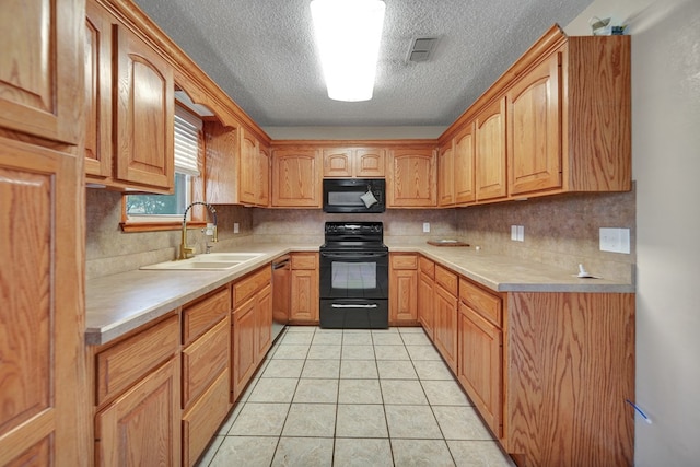 2408 Goddard Ct, Midland, TX 79705 - kitchen featuring black appliances, light countertops, a textured ceiling, tasteful backsplash, and light tile patterned floors