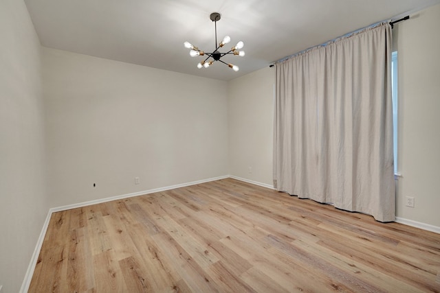 2408 Goddard Ct, Midland, TX 79705 - unfurnished room with a chandelier and wood finished floors