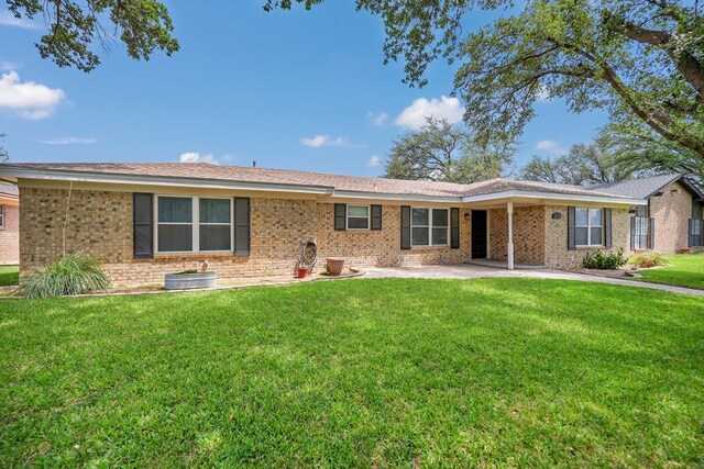 2408 Goddard Ct, Midland, TX 79705 - back of house featuring a yard, a patio, and brick siding