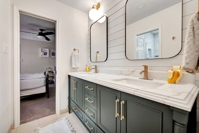 bathroom featuring tile patterned floors, connected bathroom, double vanity, and a sink