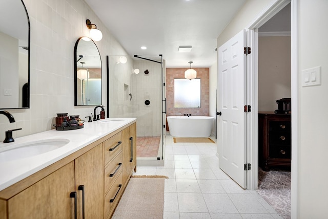 bathroom featuring a sink, a shower stall, tile patterned floors, a soaking tub, and double vanity