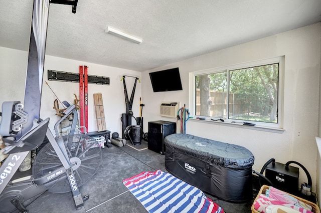 workout room featuring a textured ceiling