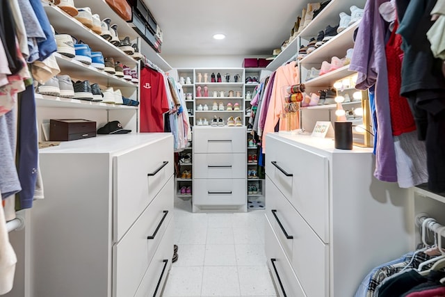 walk in closet with light floors