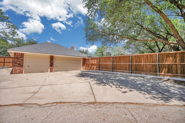 detached garage featuring fence
