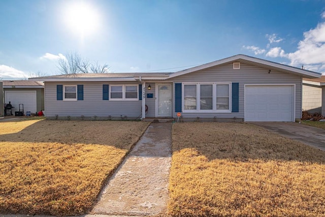 ranch-style home featuring a garage and a front yard