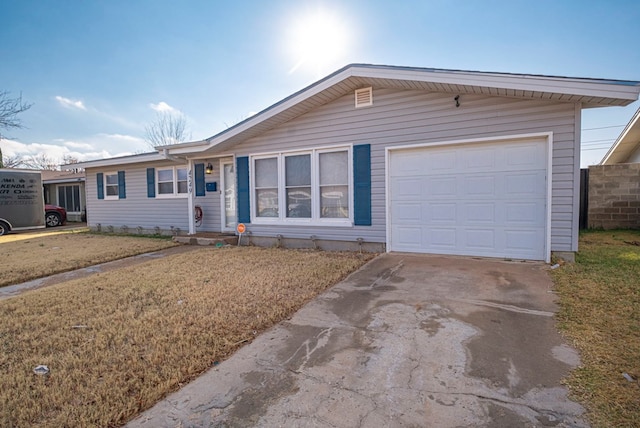 ranch-style house with a garage and a front lawn