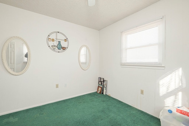 carpeted spare room featuring a textured ceiling