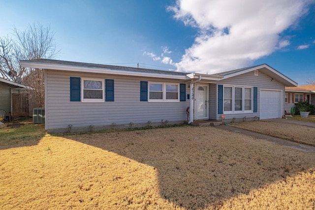 view of front of home featuring a garage, central AC unit, and a front yard