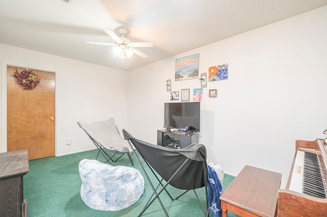 carpeted office featuring ceiling fan and a textured ceiling