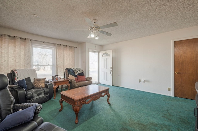 living room with ceiling fan, carpet floors, and a textured ceiling