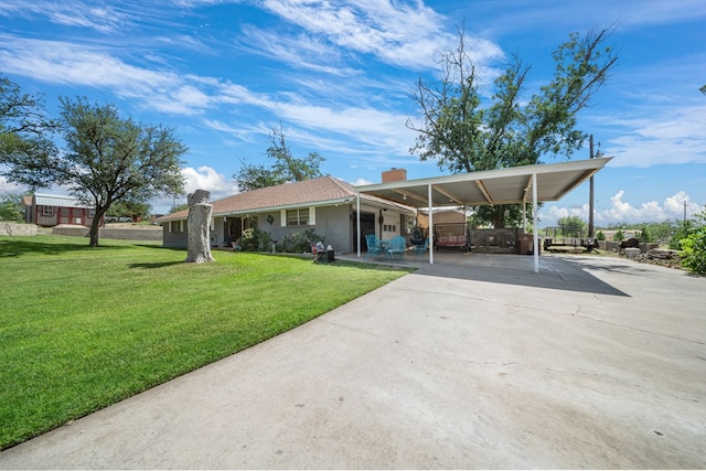 3800 Mcchristian Rd, Big Spring, TX 79720 - view of front of house featuring concrete driveway, a front yard, a chimney, and an attached carport