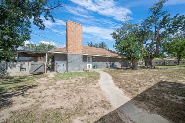 3800 Mcchristian Rd, Big Spring, TX 79720 - rear view of house featuring a chimney and a gate