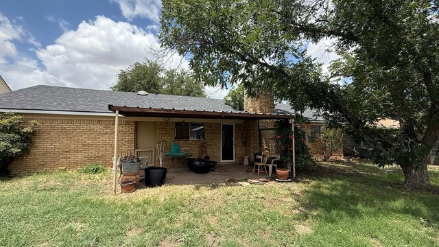 3603 Sinclair Ave, Midland, TX 79707 - rear view of house with a yard, brick siding, and a patio