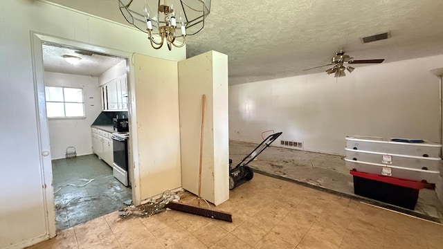 3603 Sinclair Ave, Midland, TX 79707 - kitchen featuring a ceiling fan, stove, a textured ceiling, and a chandelier