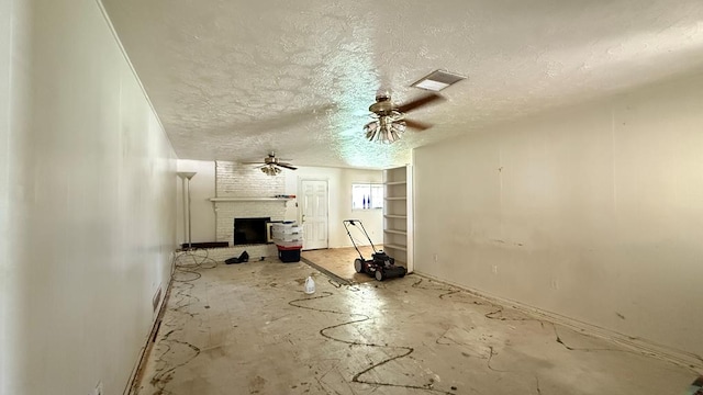 3603 Sinclair Ave, Midland, TX 79707 - unfurnished living room with a fireplace, a ceiling fan, and a textured ceiling