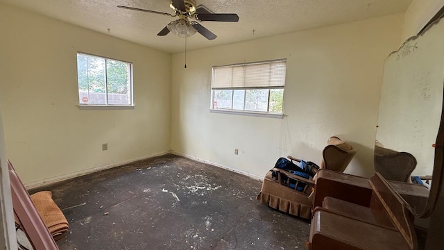 3603 Sinclair Ave, Midland, TX 79707 - unfurnished bedroom with multiple windows, unfinished concrete floors, a textured ceiling, and ceiling fan