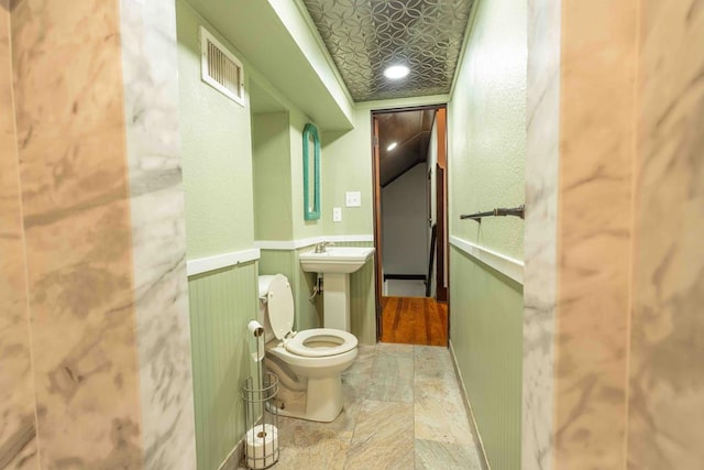 2950 Ranch Road 33, Big Spring, TX 79720 - bathroom with toilet and a wainscoted wall