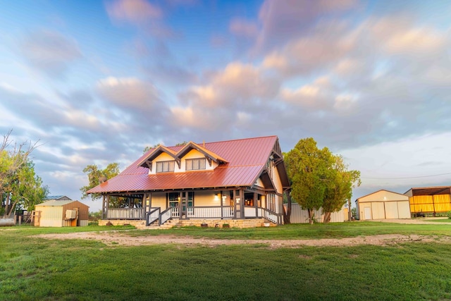 2950 Ranch Road 33, Big Spring, TX 79720 - view of front of property featuring a porch, a front yard, an outbuilding, a metal roof, and a garage