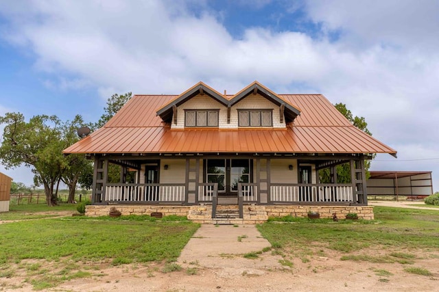 2950 Ranch Road 33, Big Spring, TX 79720 - view of front of home with covered porch, a metal roof, a front lawn, and a standing seam roof
