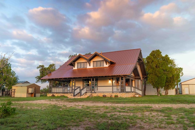 2950 Ranch Road 33, Big Spring, TX 79720 - view of front of home featuring covered porch, a front yard, a metal roof, and a storage unit