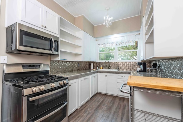 2950 Ranch Road 33, Big Spring, TX 79720 - kitchen with stainless steel appliances, open shelves, white cabinetry, and dark wood-style floors