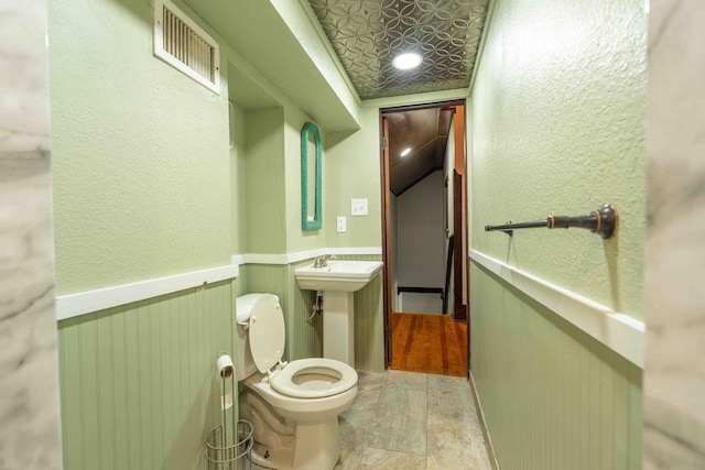 2950 Ranch Road 33, Big Spring, TX 79720 - bathroom featuring wainscoting and toilet