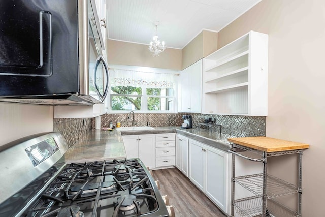 2950 Ranch Road 33, Big Spring, TX 79720 - kitchen featuring stainless steel appliances, white cabinets, a chandelier, and open shelves