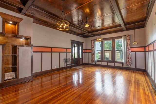2950 Ranch Road 33, Big Spring, TX 79720 - unfurnished living room with coffered ceiling, a wood ceiling with exposed beams, wood-type flooring, a decorative wall, and a chandelier