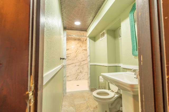 2950 Ranch Road 33, Big Spring, TX 79720 - full bath featuring a shower stall, stone tile flooring, and wainscoting