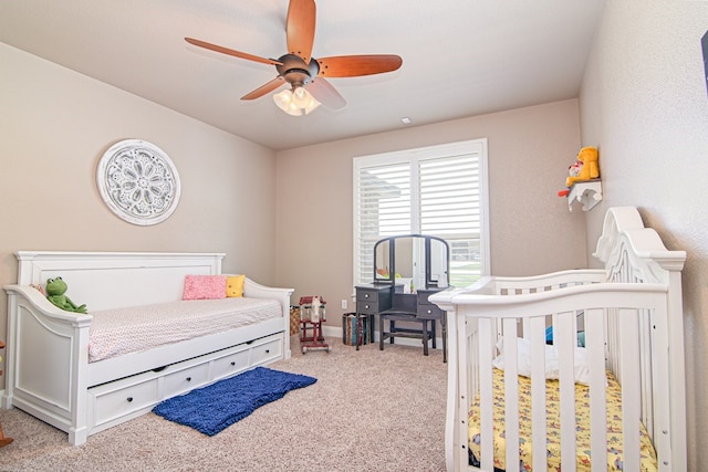 bedroom with a ceiling fan and light colored carpet