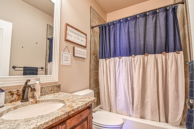 full bathroom featuring shower / bath combination with curtain, toilet, vanity, and a textured wall