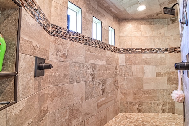 bathroom with recessed lighting and tiled shower