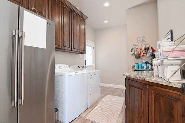 laundry room with washing machine and clothes dryer, recessed lighting, light wood finished floors, and baseboards