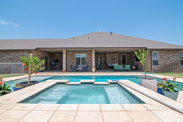 view of pool featuring a patio area, a pool with connected hot tub, and fence