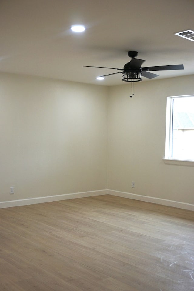 unfurnished room with ceiling fan and light wood-type flooring